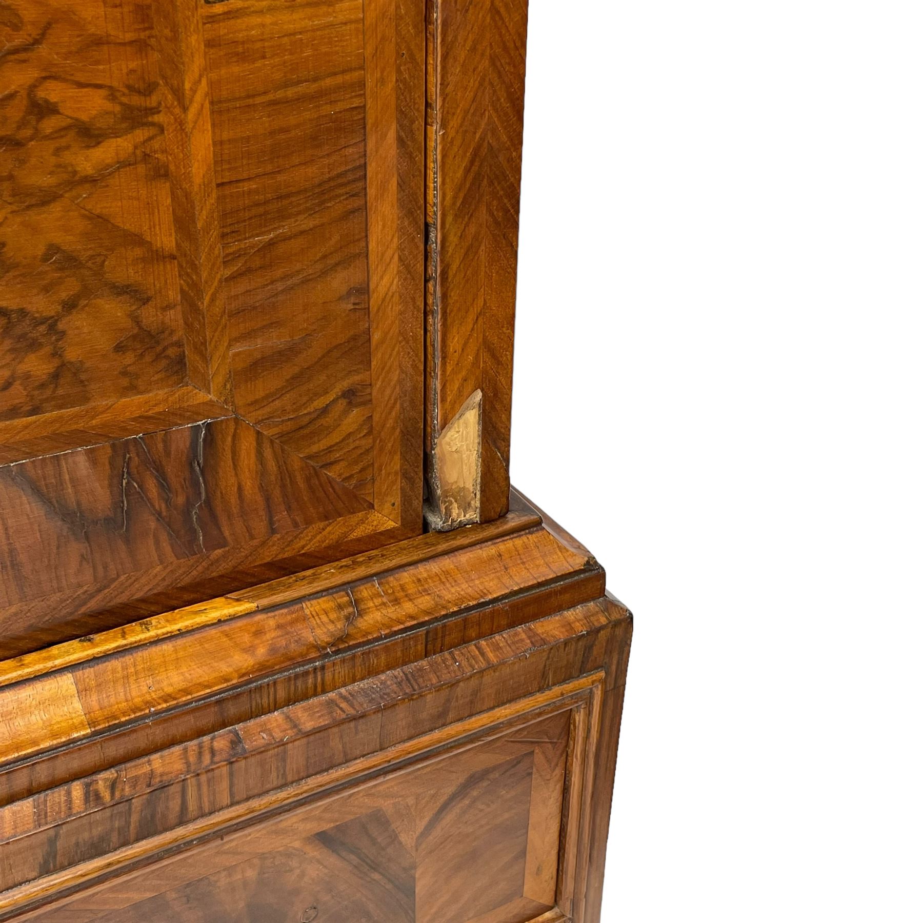 Early 18th century William & Mary figured walnut escritoire, projecting moulded cornice over shallow frieze drawer, the figured fall front enclosing interior fitted with small drawers, cupboards, pigeon holes and hidden drawers, the lower section fitted with two short and two long graduating drawers, on tall bracket feet 