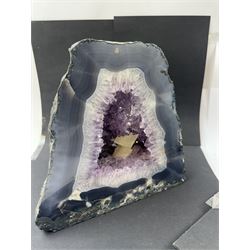 Amethyst crystal ‘cathedral’ geode, free standing with flat base and prepared outer surface, with well-defined crystals of various sizes within the cavern, H25cm, W25cm