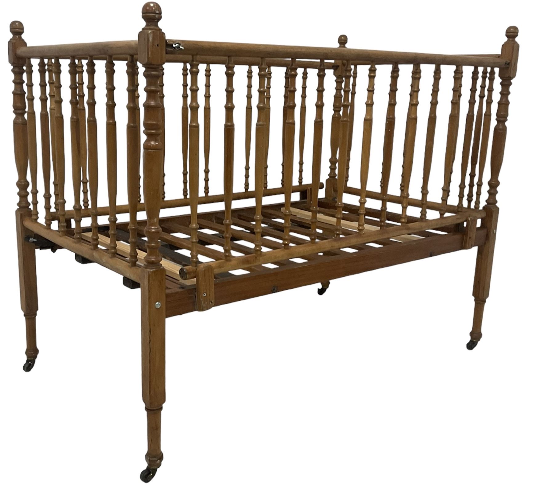 Victorian beech and pitch pine crib, turned spindle gallery supports, raised on square tapering supports with castors