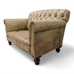 Drop-end two-seat sofa, upholstered in deeply buttoned pale green leather with stud work, on turned feet