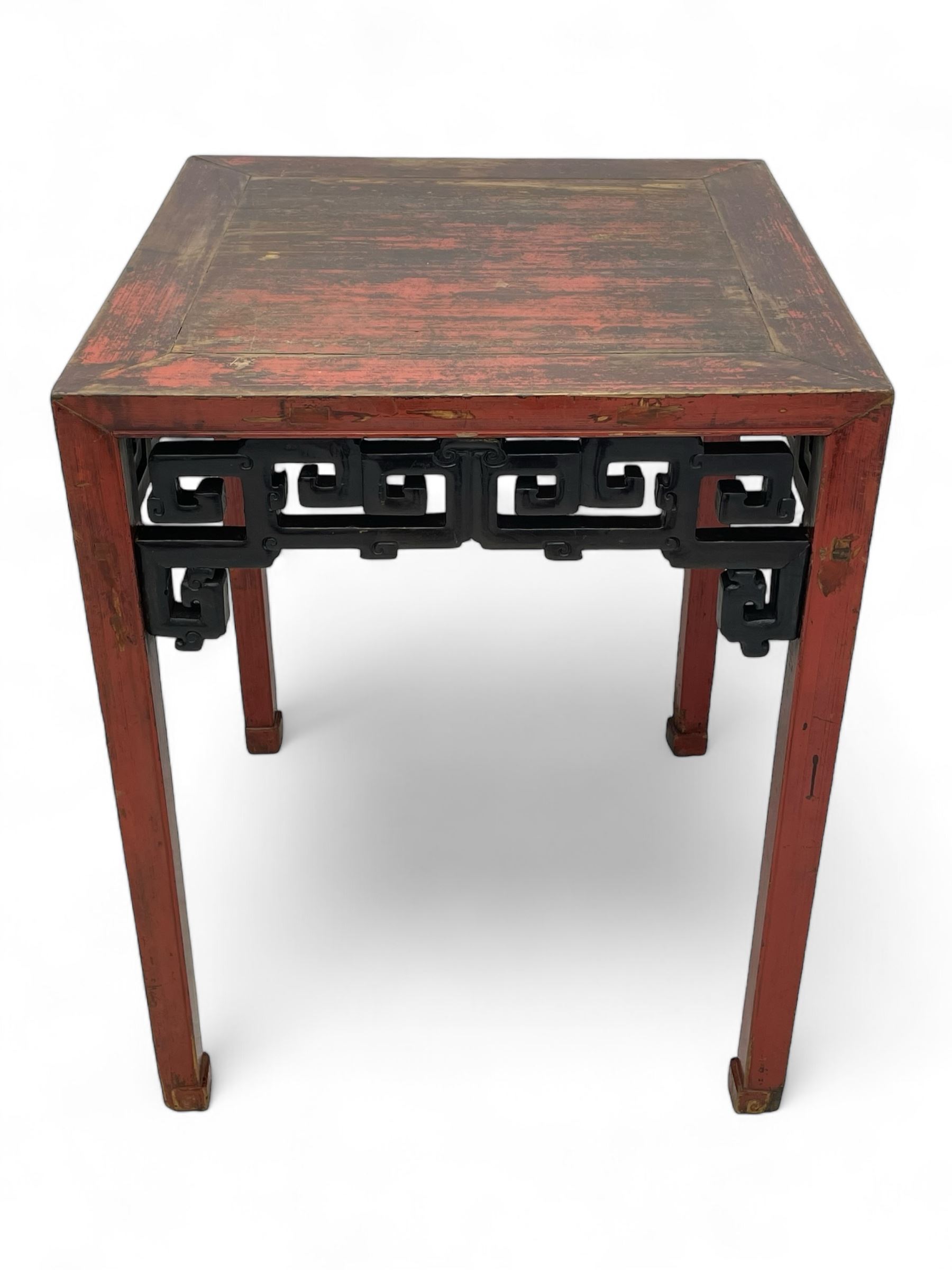 Late 19th century Chinese Qing dynasty red and black lacquered wood tall tea table, Shanxi region, square top over geometric scroll fretwork panels, on square supports with hoof feet 