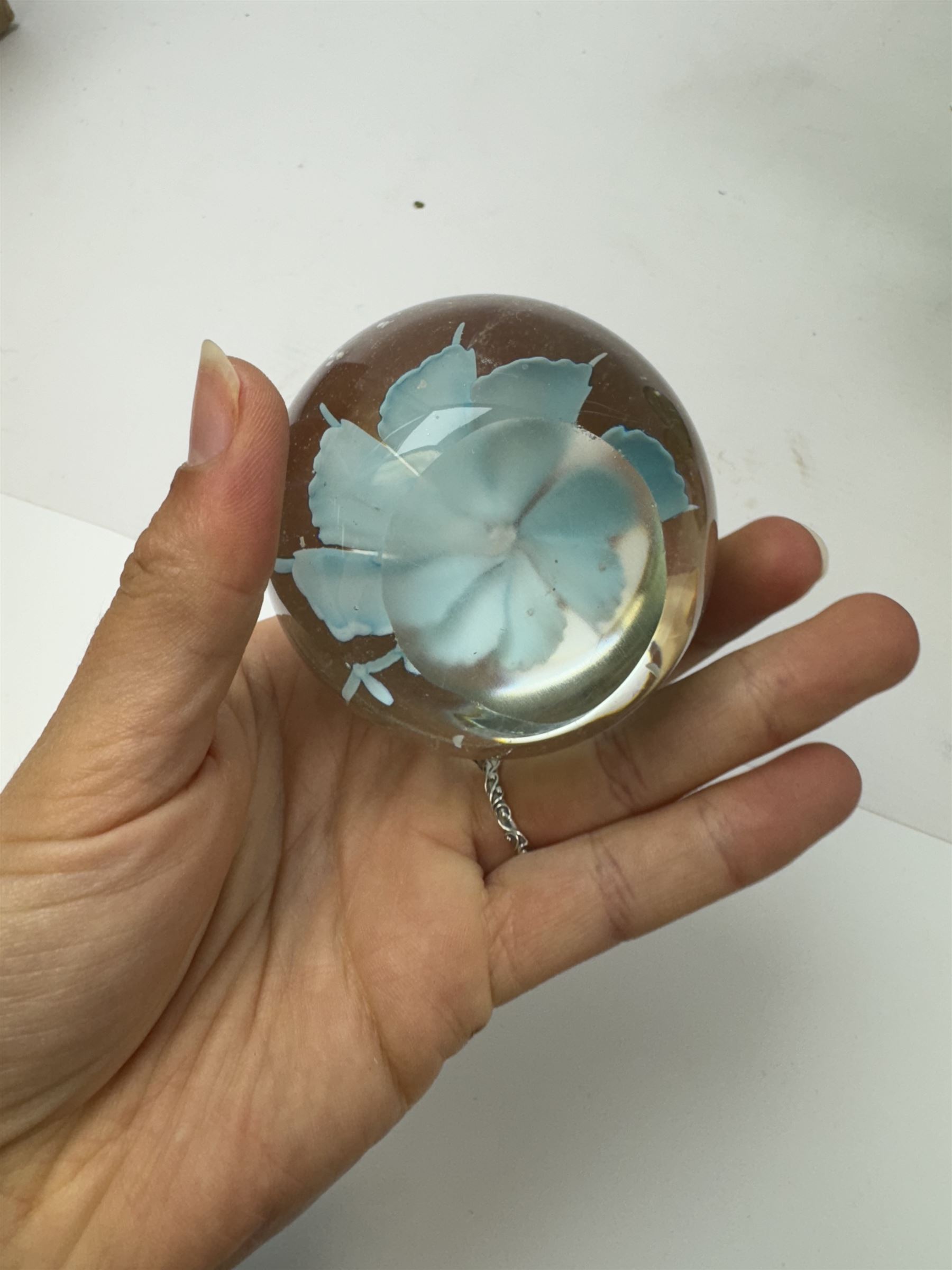 Two glass dump paperweights, with flower inclusions, together with four further glass paperweights