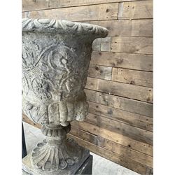 Pair of Georgian design cast stone garden urns, egg and dart rim with raised floral motifs, pedestal base terminating on square plinth, raised on square block plinth