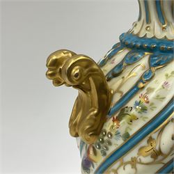 Pair of late 19th/early 20th century Sevres style vases and covers, of baluster form with gilt scroll handles and domed covers, the wrythen fluted bodies decorated with alternating bands of painted fruit and flowers and gilt vines, upon a white and celeste blue ground, with printed and impressed marks beneath, H22.5cm 