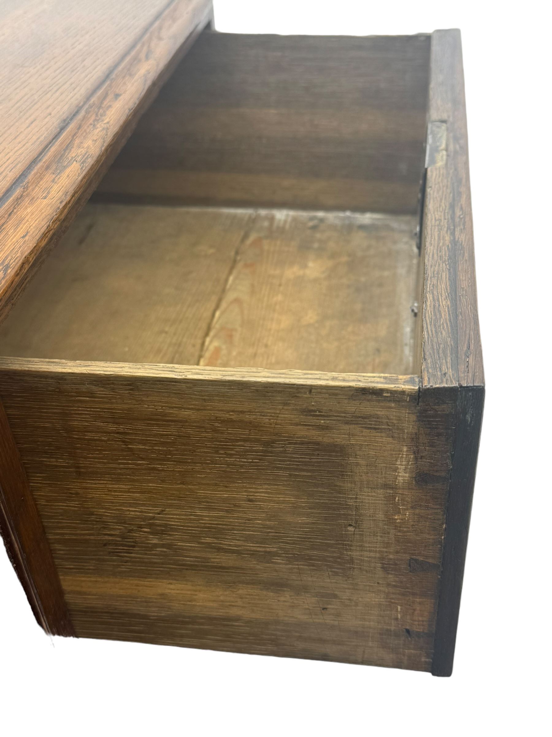 George III oak chest, rectangular top with moulded edge over two short and three long graduated drawers, each with brass escutcheons and shaped backplate handles, on turned bun supports 