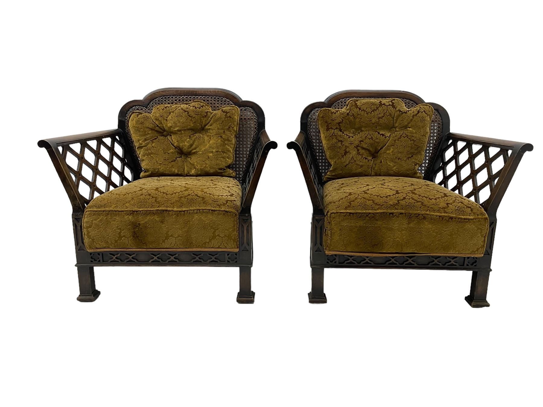 Early 20th century three-piece bergère suite - three seat sofa (W177cm, H82cm, D75cm); pair of matching armchairs (W84cm); single caned back with 'cock-pen' panelled arms, upholstered in foliate pattern fabric, blind fretwork lower frieze over square feet 