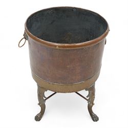 19th century copper and brass log basket, fitted with twin lion mask handles, raised on acanthus cast cabriole supports terminating to paw feet, united by X-stretcher