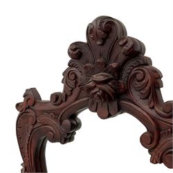 Pair of carved hardwood wall mirrors, shaped floral carved pediment over trailing and scrolled foliage decoration, plain mirror plate 