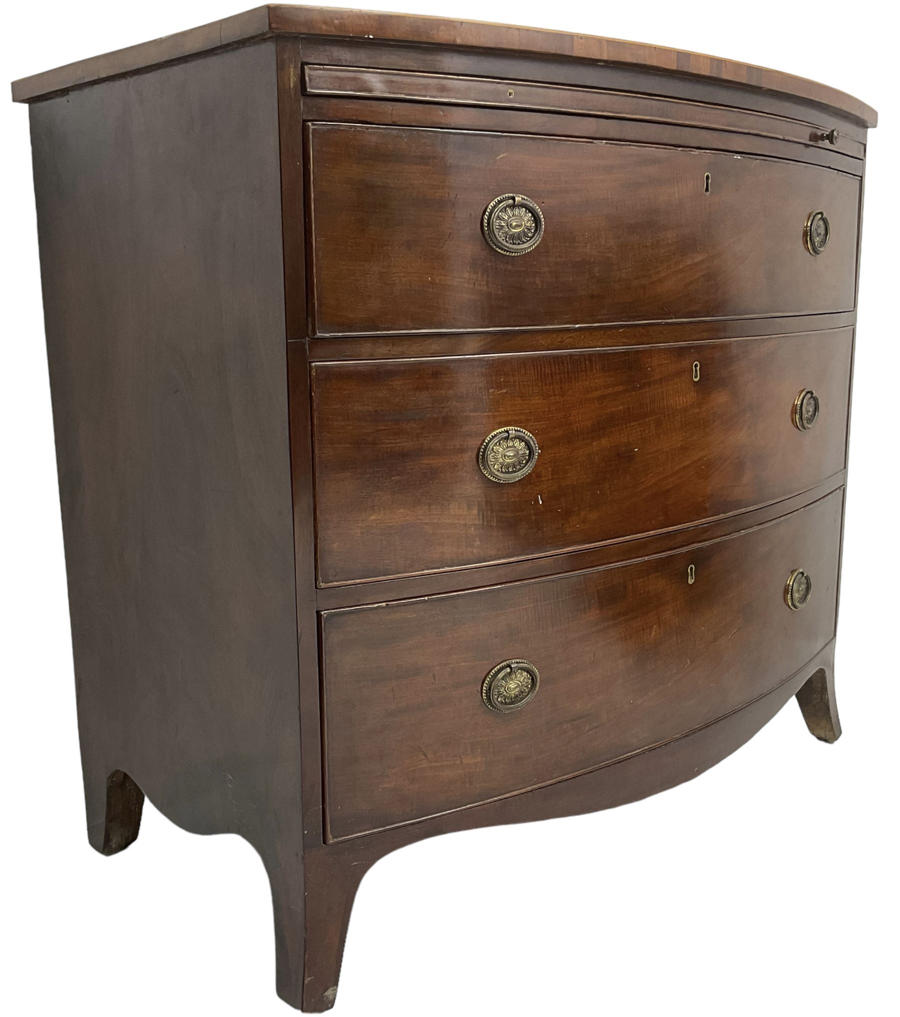 George III mahogany bow-front chest, shaped top with satinwood stringing, fitted with brushing slide over three graduating cock-beaded drawers, shaped apron over bracket feet