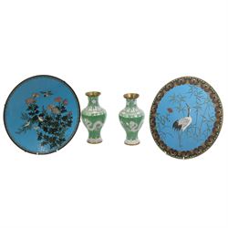 Chinese cloisonne plate, centrally decorated with birds perched on a blossoming tree, D30.5cm, a similar circular wall plaque, decorated with a Crane, together with a pair of Cloisonne green ground vases (4)