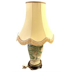 Oriental style table lamp, of baluster form, decorated with landscape scenes, with fabric shade, overall H70cm