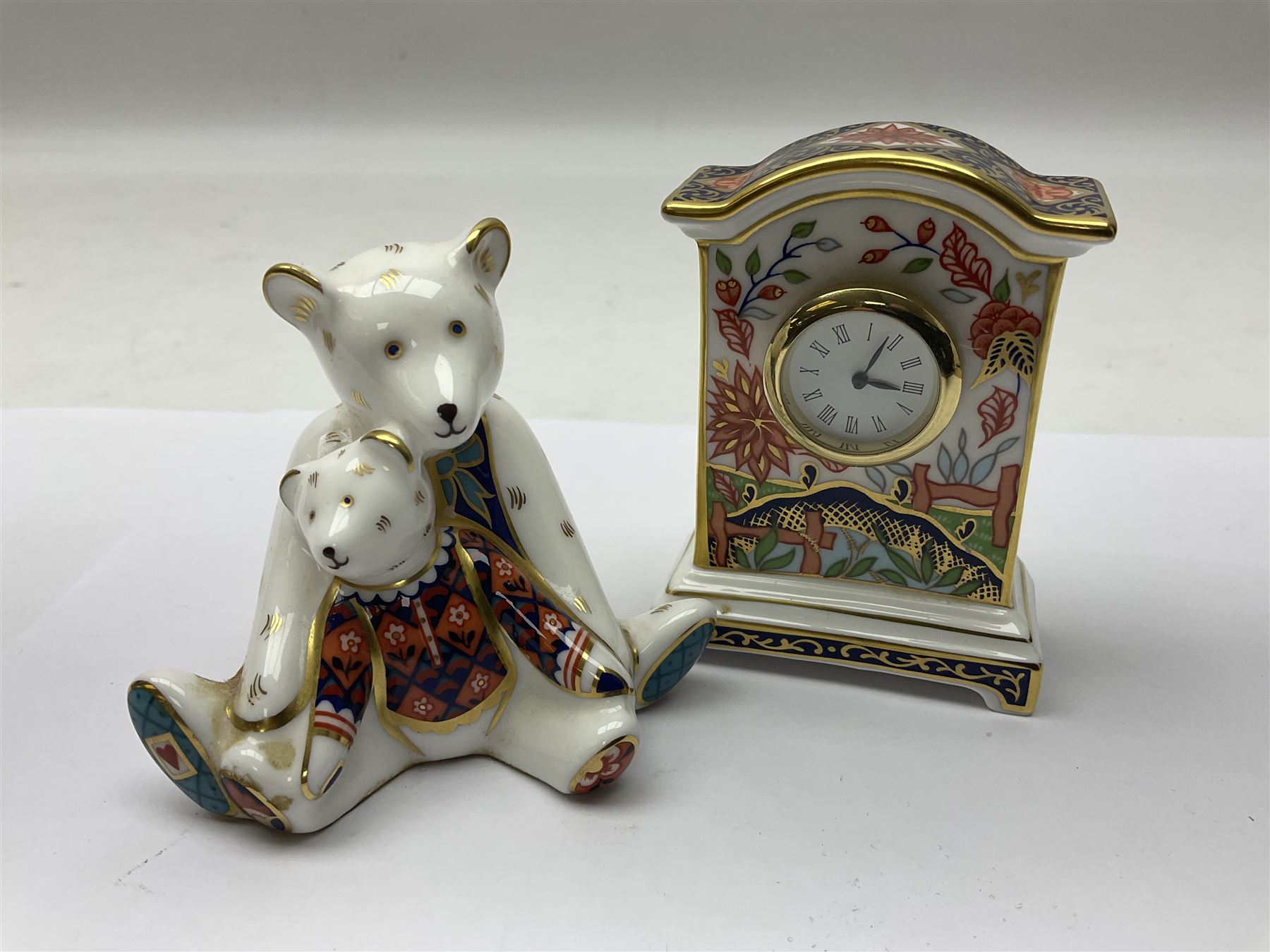 Royal Crown Derby Haiku pattern miniature clock, together with 1128 Imari pattern trinket box with cover and teddy bear figure, all with printed marks beneath   