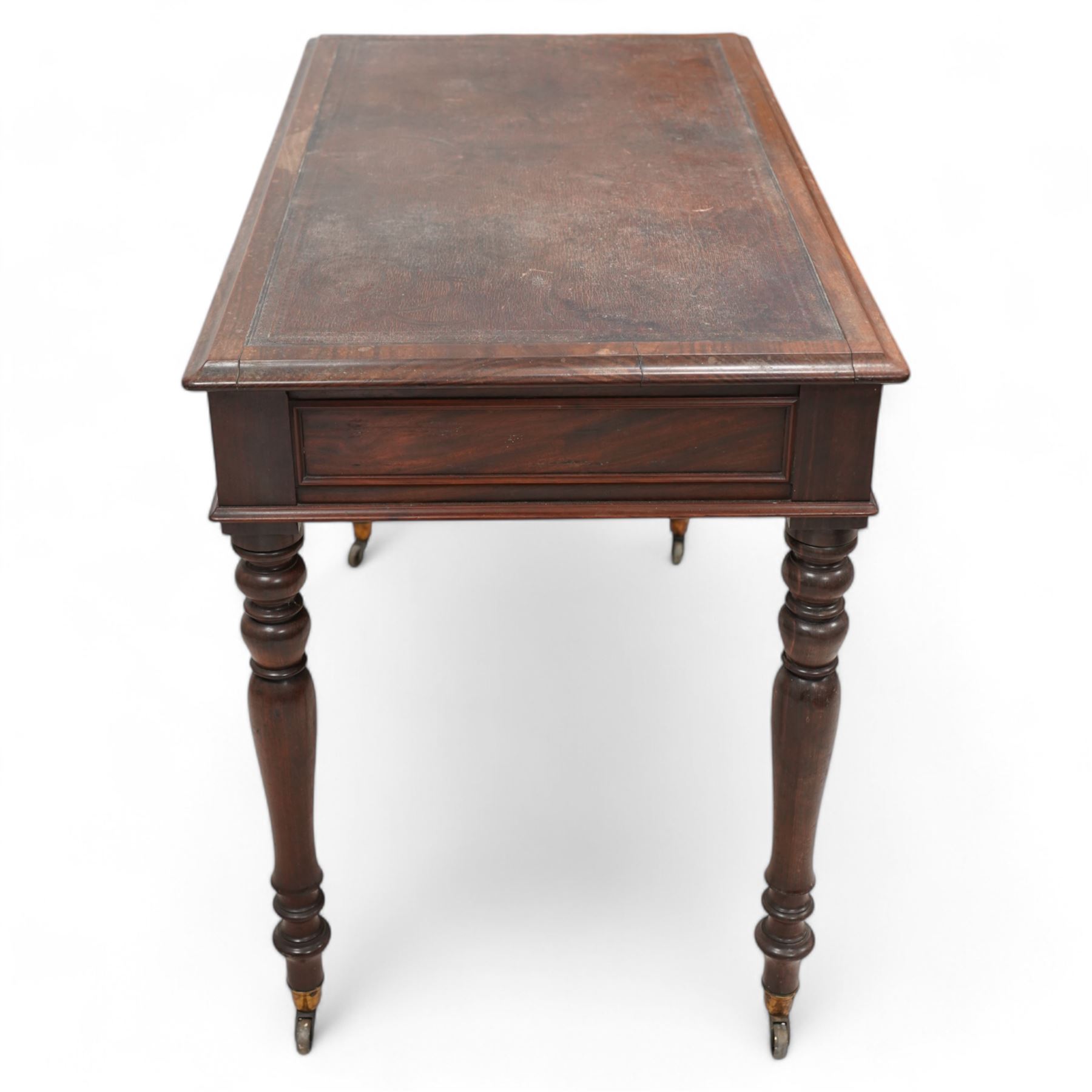 19th century mahogany writing table, rectangular top with moulded edge inset with leather writing surface, fitted with two frieze drawers with moulded facias, raised on turned supports terminating to brass cups and castors