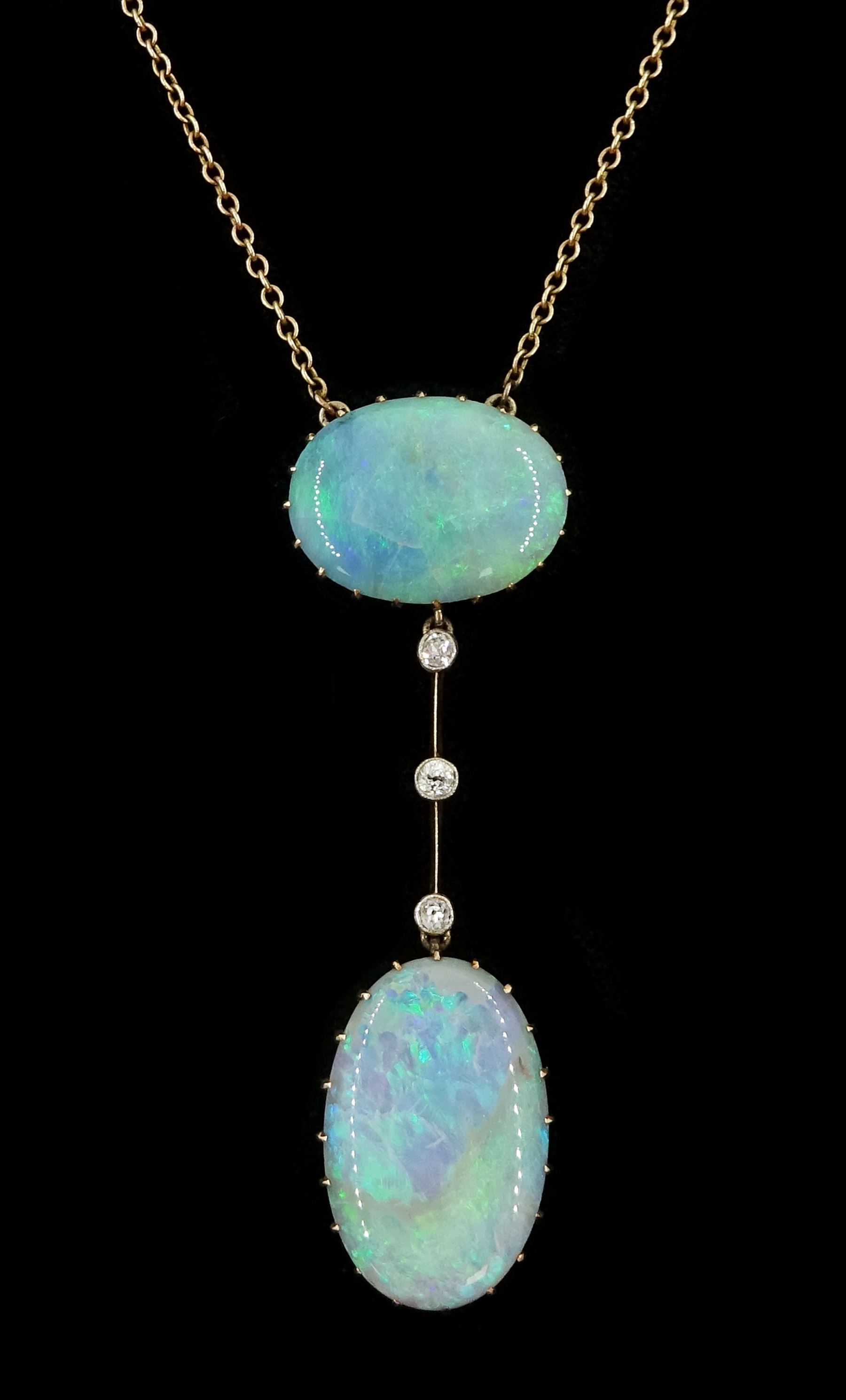 Early 20th century gold opal and diamond pendant necklace, two oval cabochon cut opals spaced by three milgrain set old cut diamonds, total opal weight approx 16.85 carat