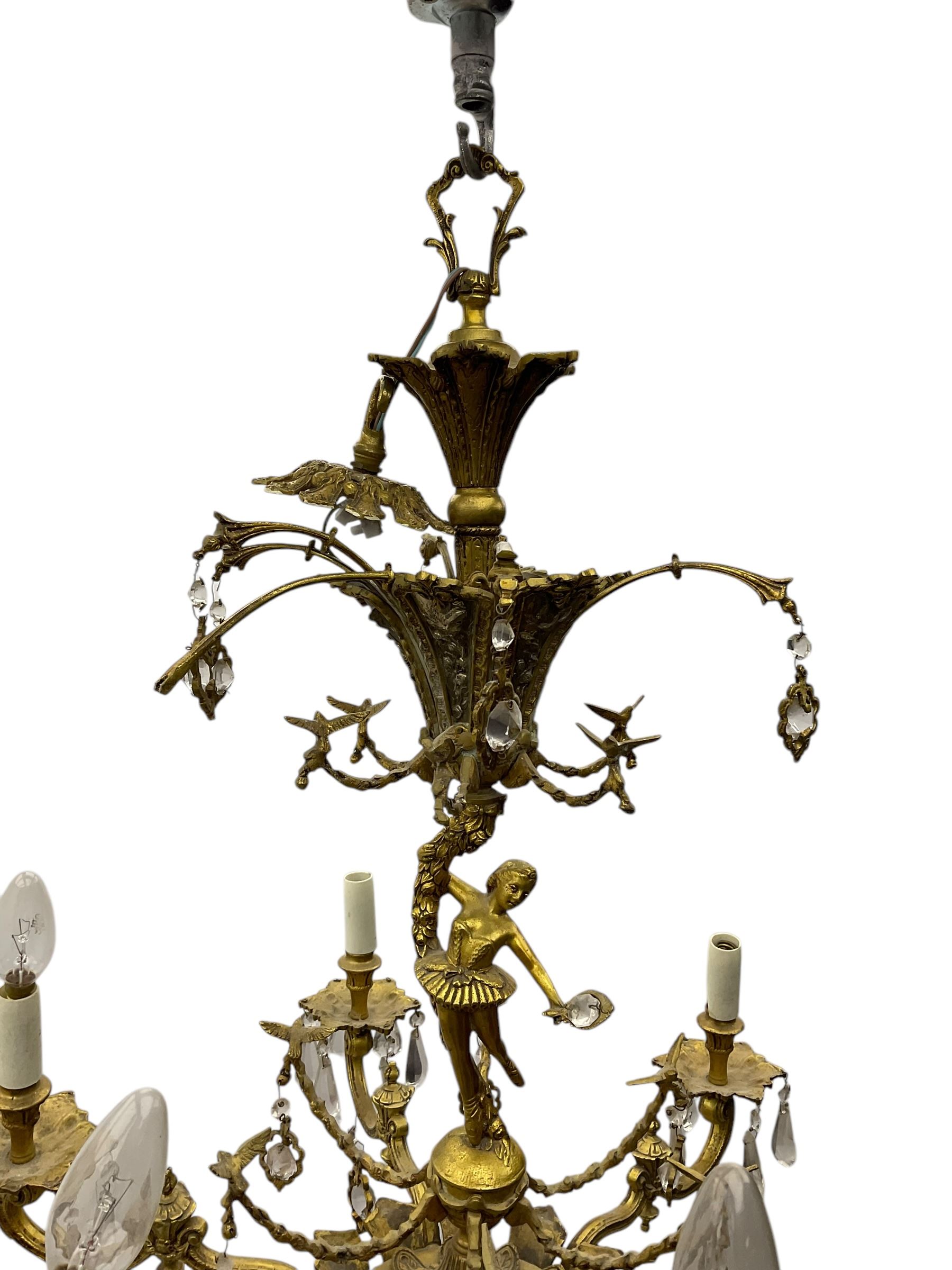 Gilt metal six branch ceiling light, the central stem modelled as a ballerina, decorated with glass pendants 