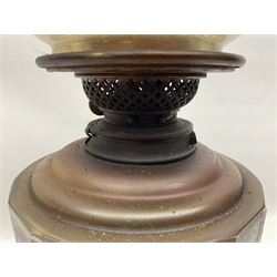 Victorian oil lamp, the faceted reservoir upon embossed copper stem and stepped circular ceramic base, with etched floral glass shade