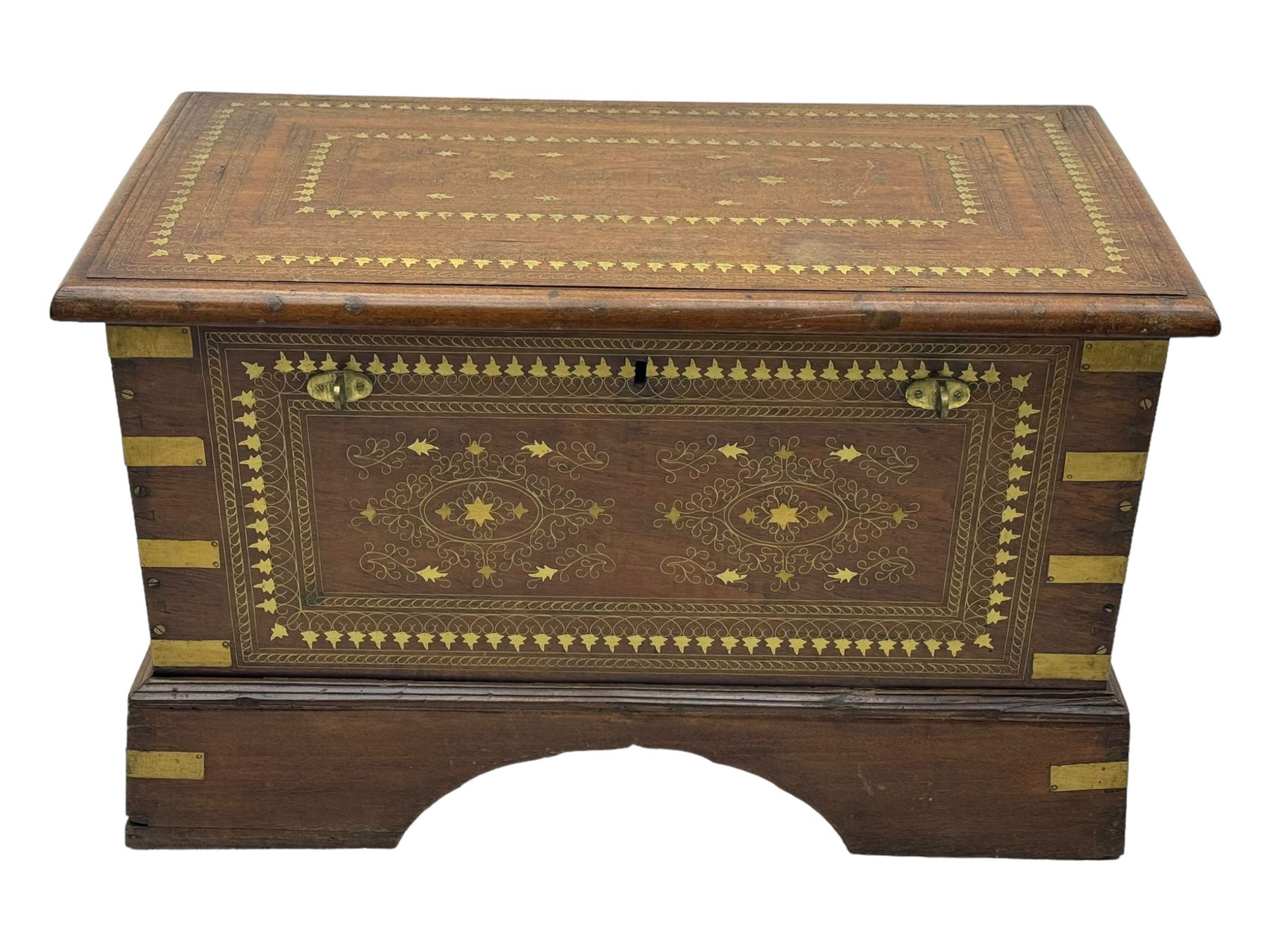 20th century mahogany chest, rectangular hinged top enclosing removable compartments with carved starburst motifs with linear and geometric patterns, brass inlay to the top and front, mounted corners and edges, on bracket base