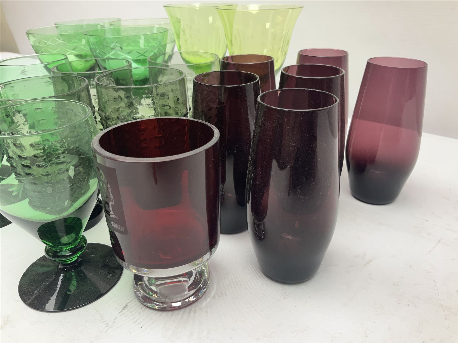 Set of four Swedish Reijmyre drinking glasses, with textured outer surface, together with green drinking glasses including Holmegaard examples and other glassware