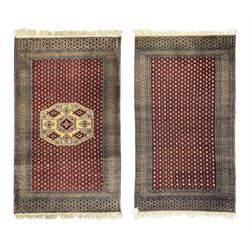 Pakistani Kashan hand-knotted rug with a central medallion and intricate geometric floral patterns, set against a red field and framed by a multi-band border; Pakistani Kashan rug with a repeating floral motif across the red field, enclosed by a detailed geometric border in complementary tones (2)