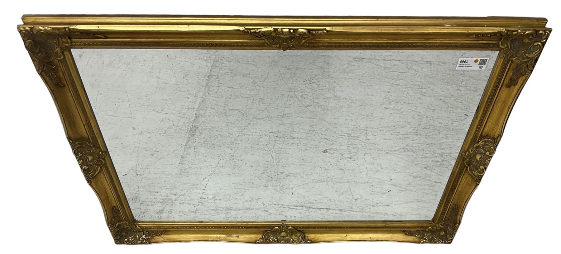 Swept gilt framed wall mirror with rectangular bevelled plate