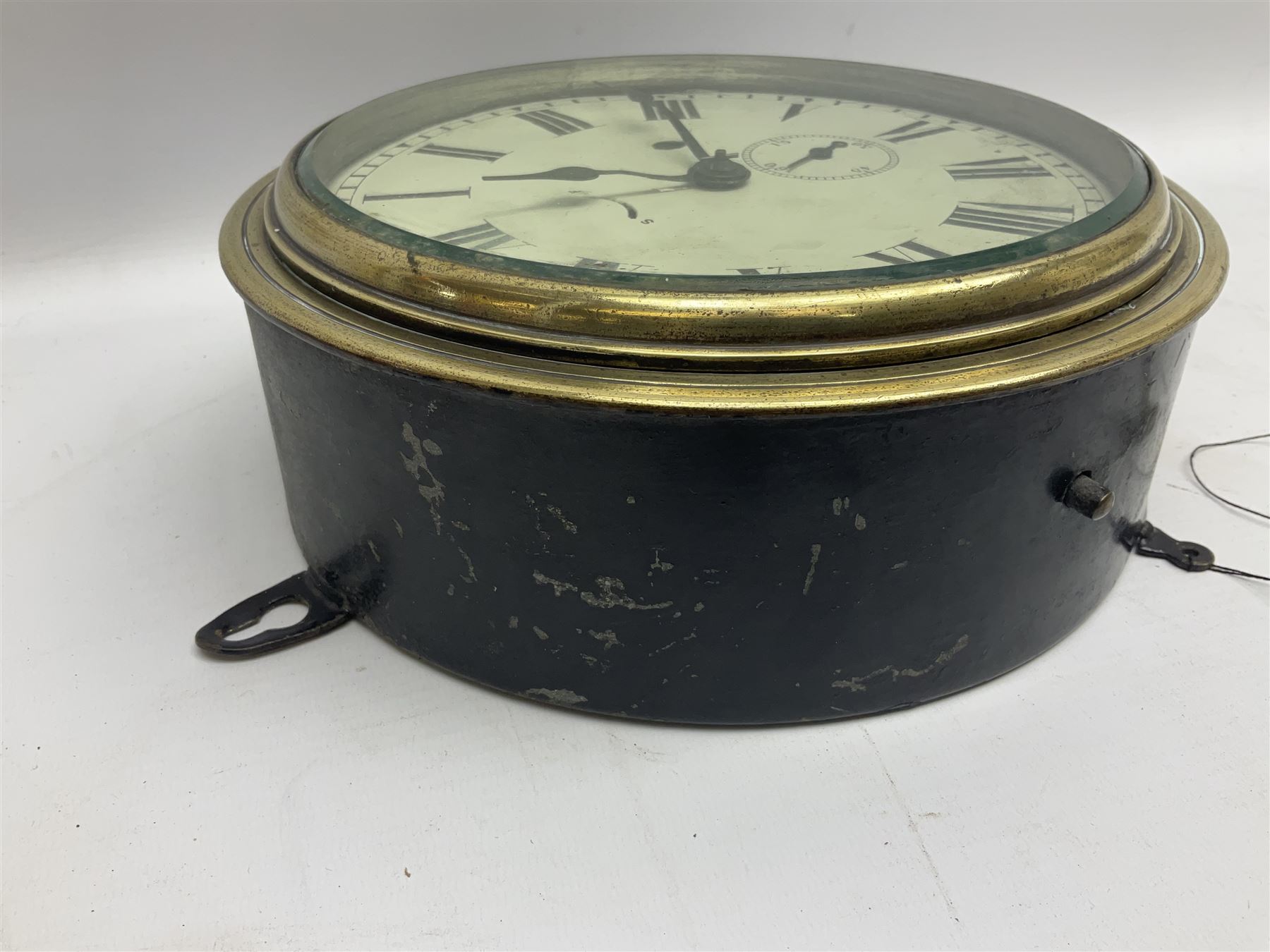 Seth Thomas ship's bulkhead clock with brass bezel and japanned case, the white dial with Roman numerals and subsidiary seconds dial D23.5cm; with key