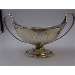 Pair of George III twin handled silver salts, of navette form with beaded rim and twin whiplash handles, each engraved to body with crest, upon stepped oval foot, London 1784, H8.5cm