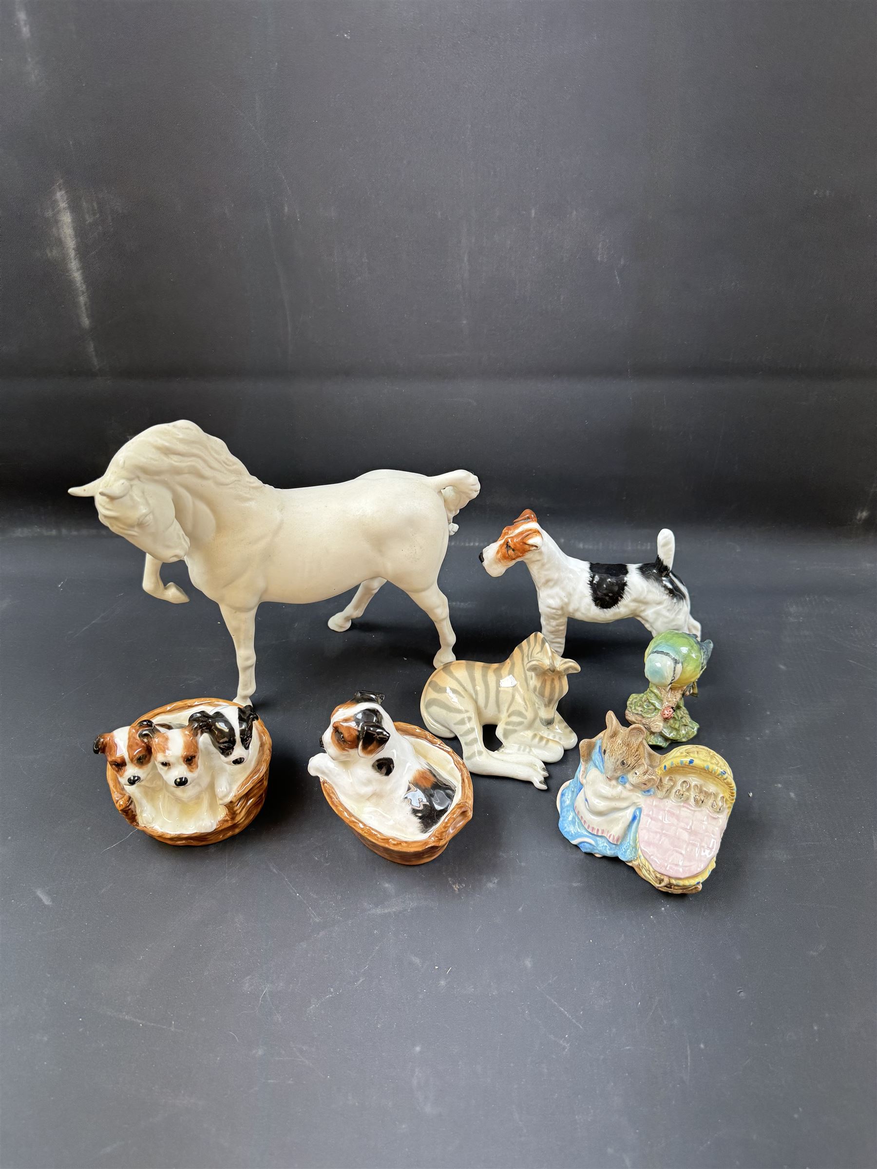 Two Royal Doulton figures of puppies in baskets, together with Beswick horse and other animal figures