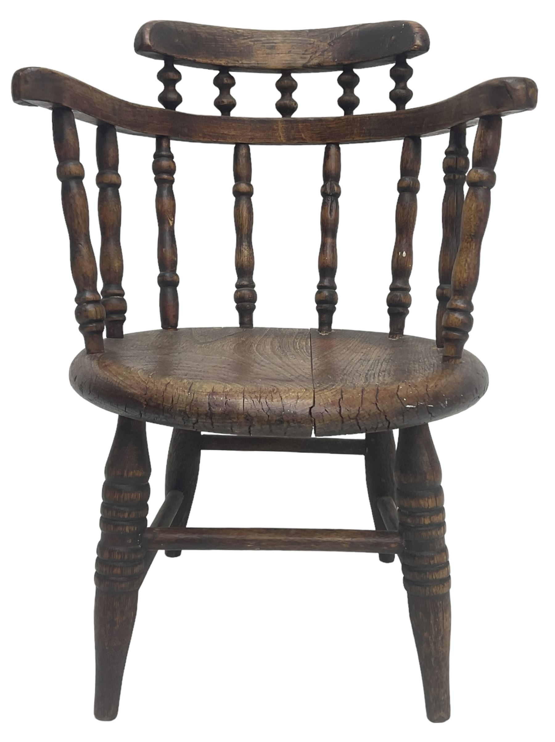 19th century child's spindle back armchair, curved cresting rail over bow arms on spindle supports, circular seat on ring turned supports united by turned stretchers 