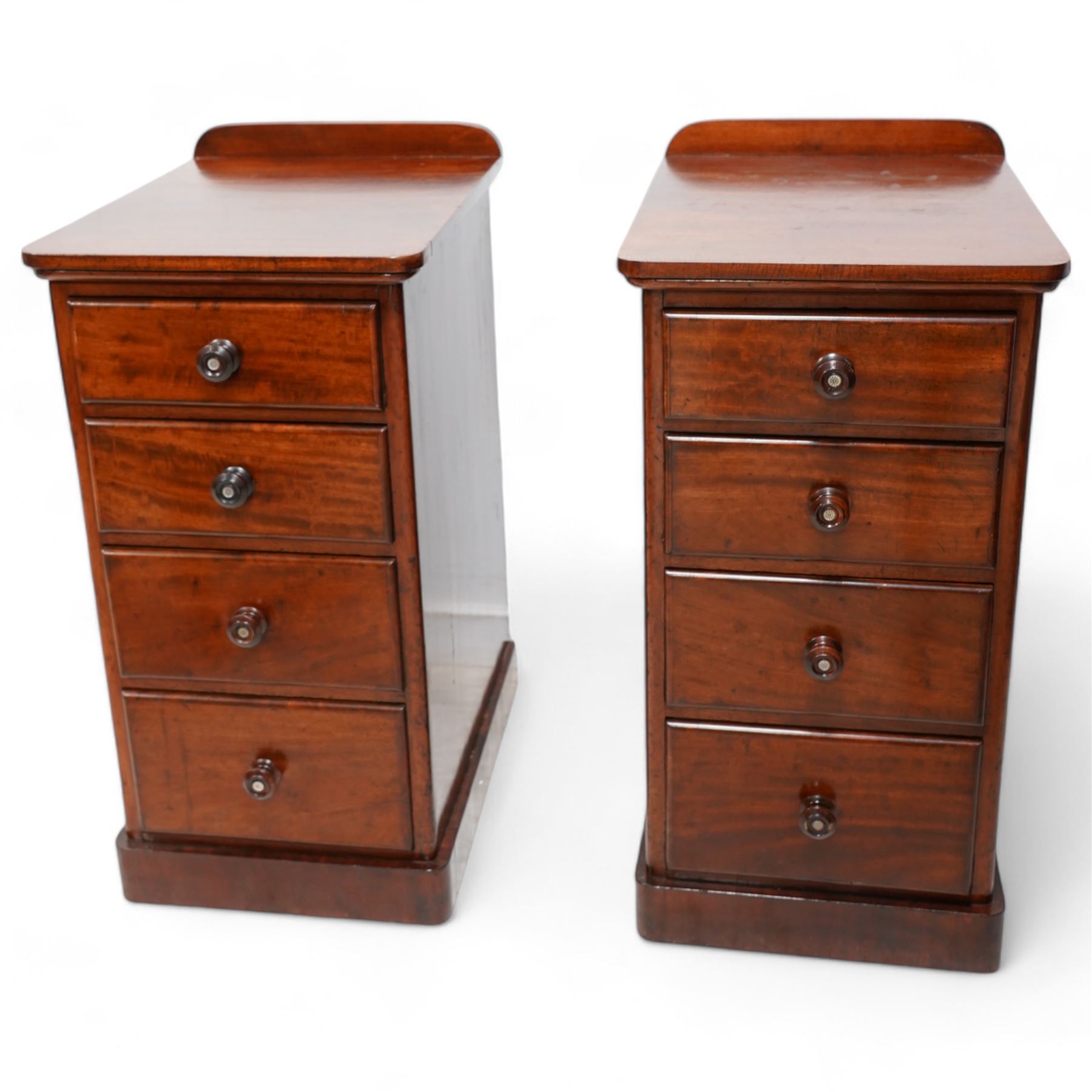 Pair of Victorian mahogany bedside pedestal chests, raised back over rectangular top with rounded front corners, fitted with four graduating drawers, on plinth base 