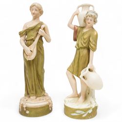 Pair of Royal Dux figures, modelled as a boy carrying pails of water and a lady playing a ...