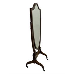 S. & H. Jewell - Edwardian mahogany cheval dressing mirror, shield shaped bevel edged mirror plate within an inlaid mahogany frame, supported by a pair of curved uprights topped with finials and terminating in a scroll design with floral inlay, the reverse bearing makers plaque, standing on four shaped supports fitted with brass castors