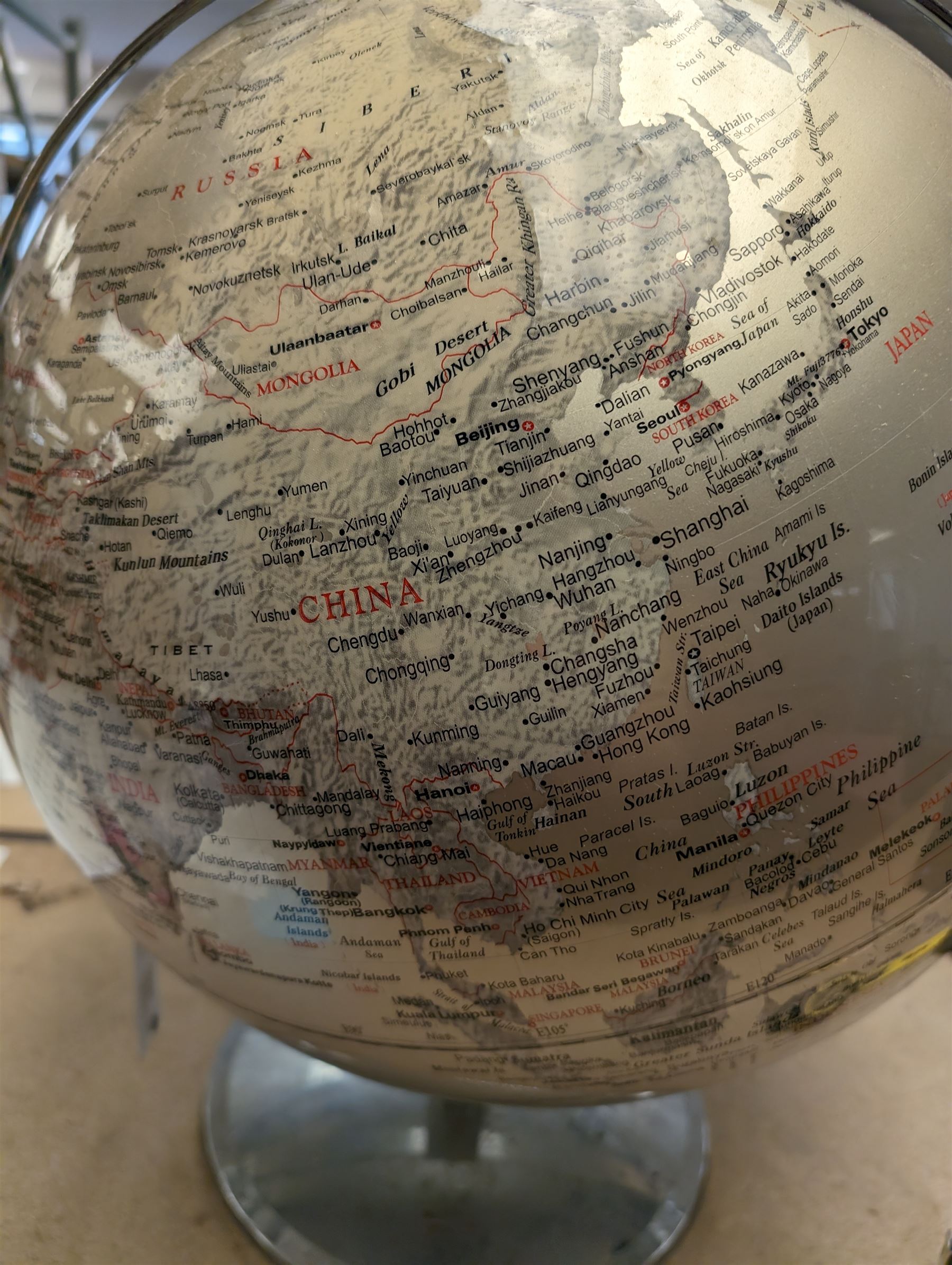 World globe, with red and black writing on a silvered ground, H50cm