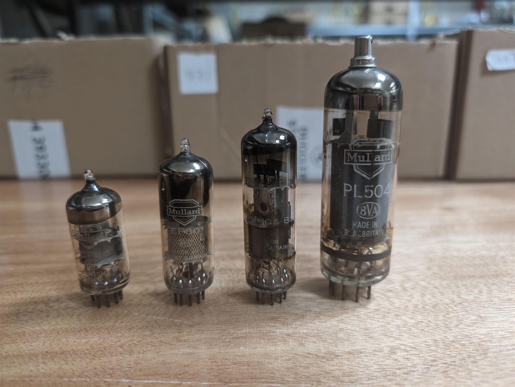 Collection of Mullard thermionic radio valves/vacuum tubes, mostly bubble wrapped and identified with lists