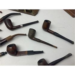 Collection of smoking pipes including Meerschaum pipe, carved as a female head, Briars and clay examples, etc and four pipe racks/stands