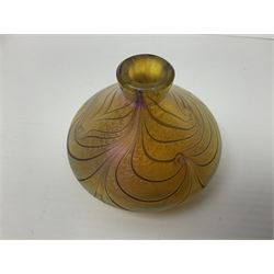 Four Okra scent bottles, the first example modelled as an apple, the second of squat form decorated with iridescent threads upon a gold ground and two others 