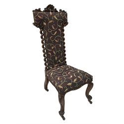 Victorian walnut prie-dieu chair, cresting rail carved with cartouche and extending scrolling foliage, back flanked by spiral turned column uprights, upholstered in foliate patterned fabric, raised on cabriole supports with scroll feet and castors