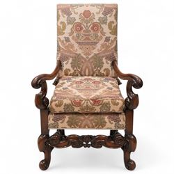 Carolean design walnut framed open armchair, upholstered in floral pattern fabric, shaped ...