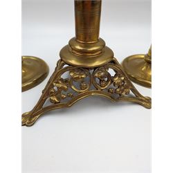 Brass candlestick with a knopt stems and triform base, together with two other brass candlestick 