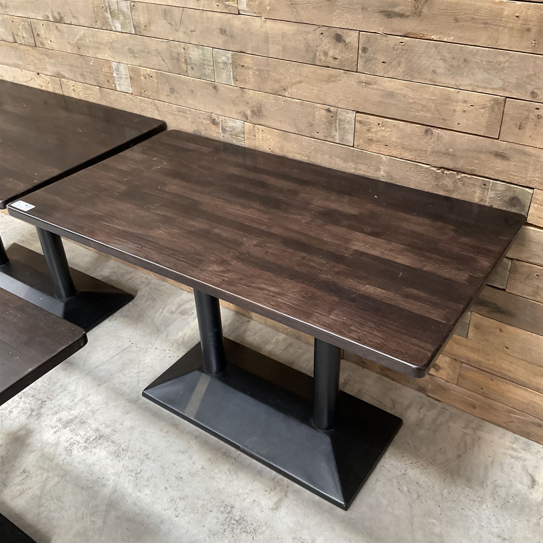 Three dark walnut rectangular console restaurant tables, on black metal bases