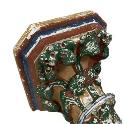 Two Victorian polychromed plaster cast corbels or wall brackets, canted rectangular tops over moulded edge and curled fruiting foliage