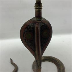 Indian brass pedestal dish, the dish engraved with peacock to centre, the stem modelled as a King Cobra, with engraved and enamelled decoration throughout, together with a similar pair of candlesticks, modelled as King Cobras, dish H23.5cm 