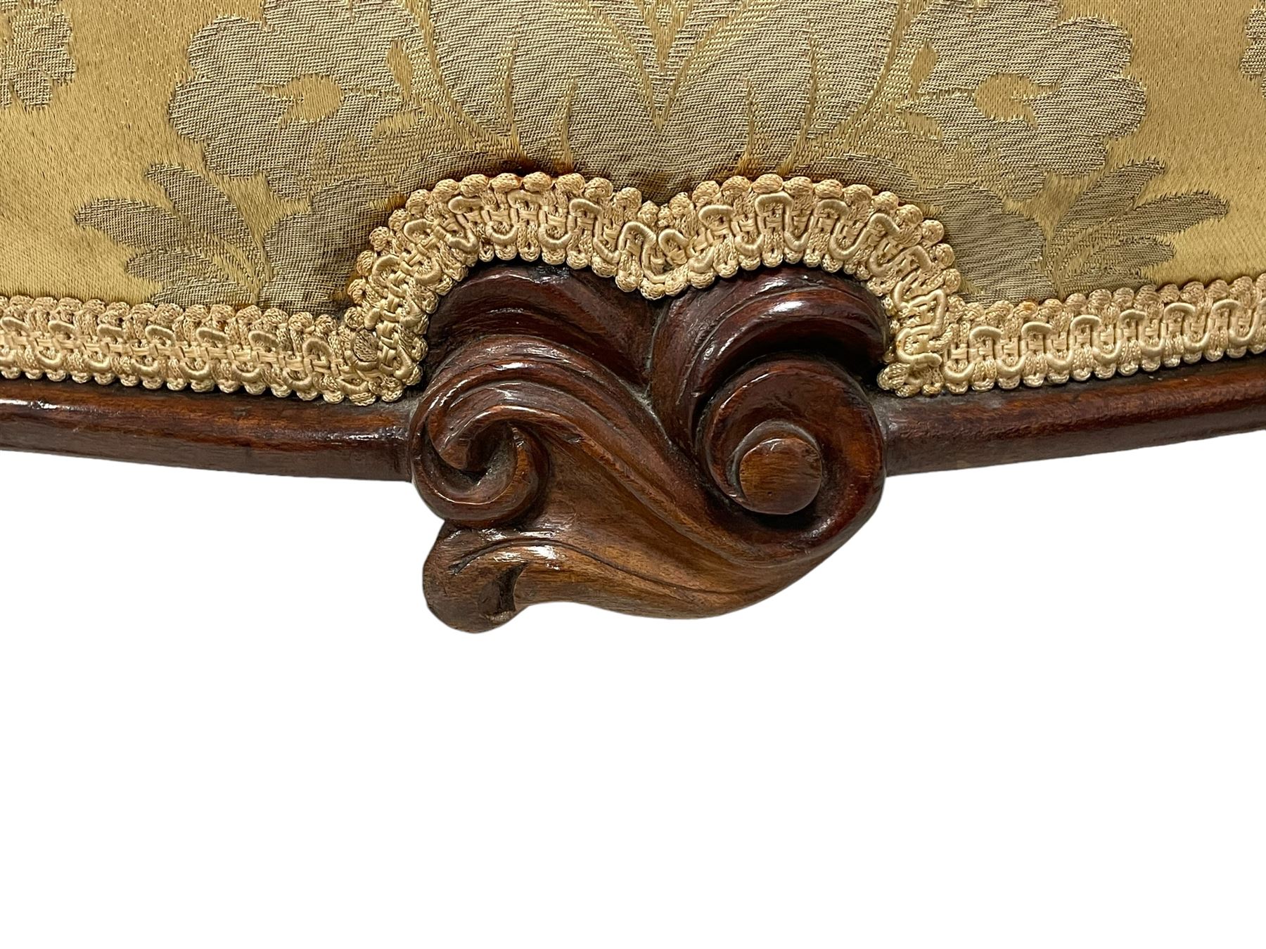 Victorian mahogany framed armchair, shaped and moulded frame carved with curled foliage, upholstered in pale gold floral pattern silk damask fabric, scrolled arm terminals on shaped moulded supports terminating to scroll carved feet