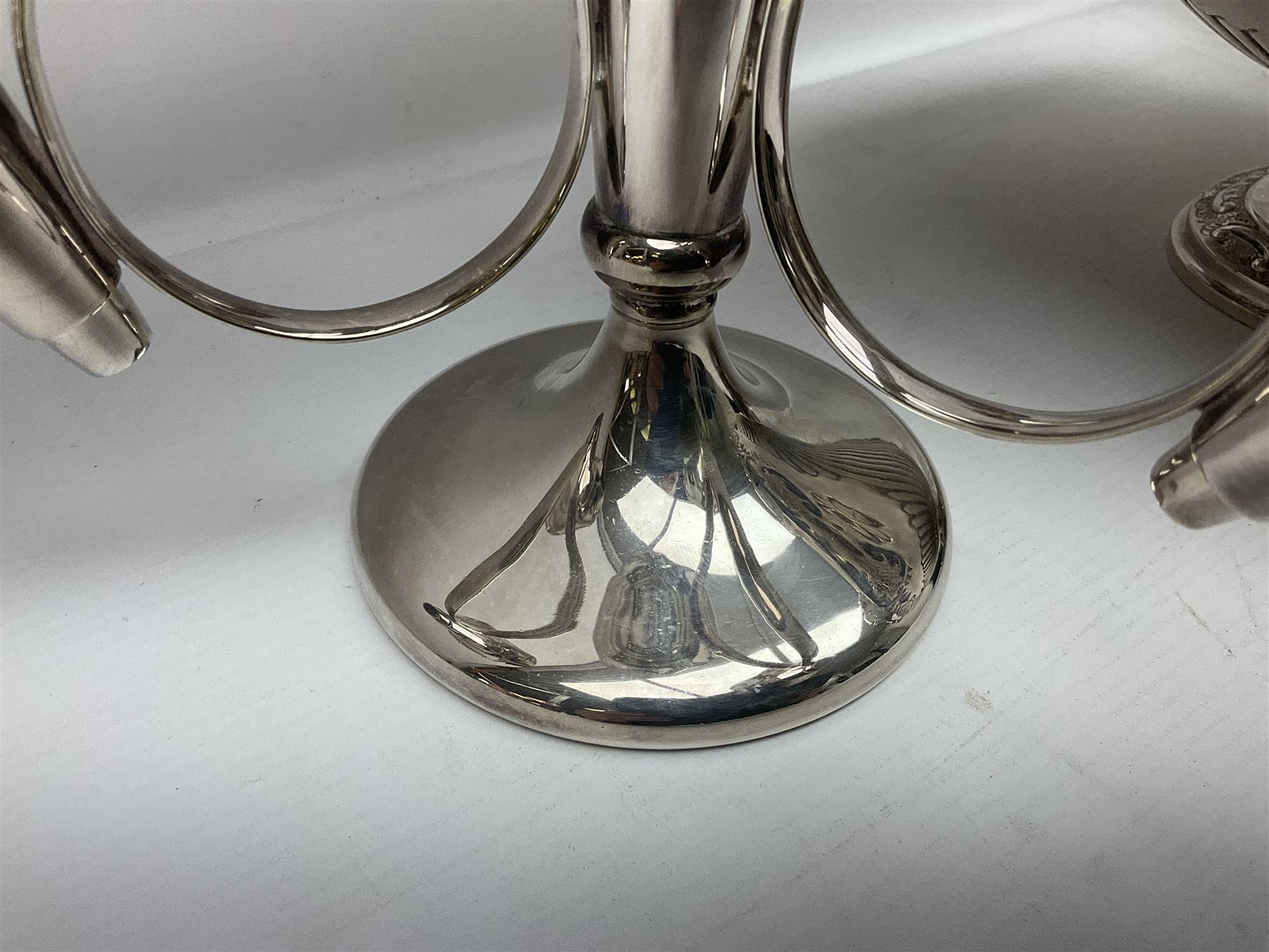 Silver plated three branch epergne, together with a silver plated cut glass claret jug, and silver plated embossed swing handled basket, epergne H30.5cm