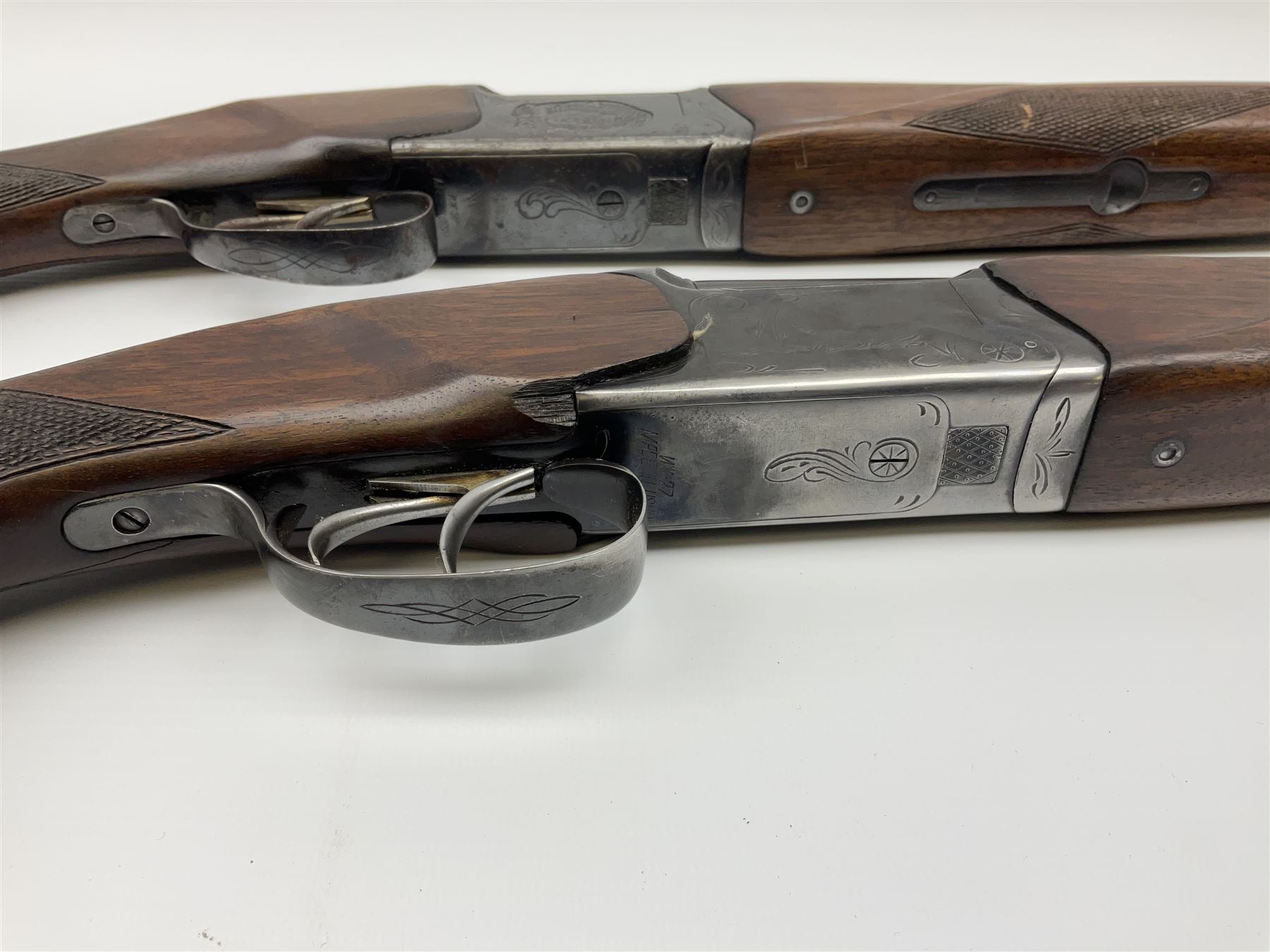 Two Russian Baikal 12-bore over-and-under double barrel boxlock non-ejector sporting guns; one with 68.5cm barrels, walnut stock with chequered pistol grip and fore-end and thumb safety, serial no.520545, L111cm overall; the other with 72.5cm barrels, walnut stock with chequered pistol grip and fore-end and thumb safety, serial no.012448, L114.5cm overall (2) SHOTGUN CERTIFICATE REQUIRED