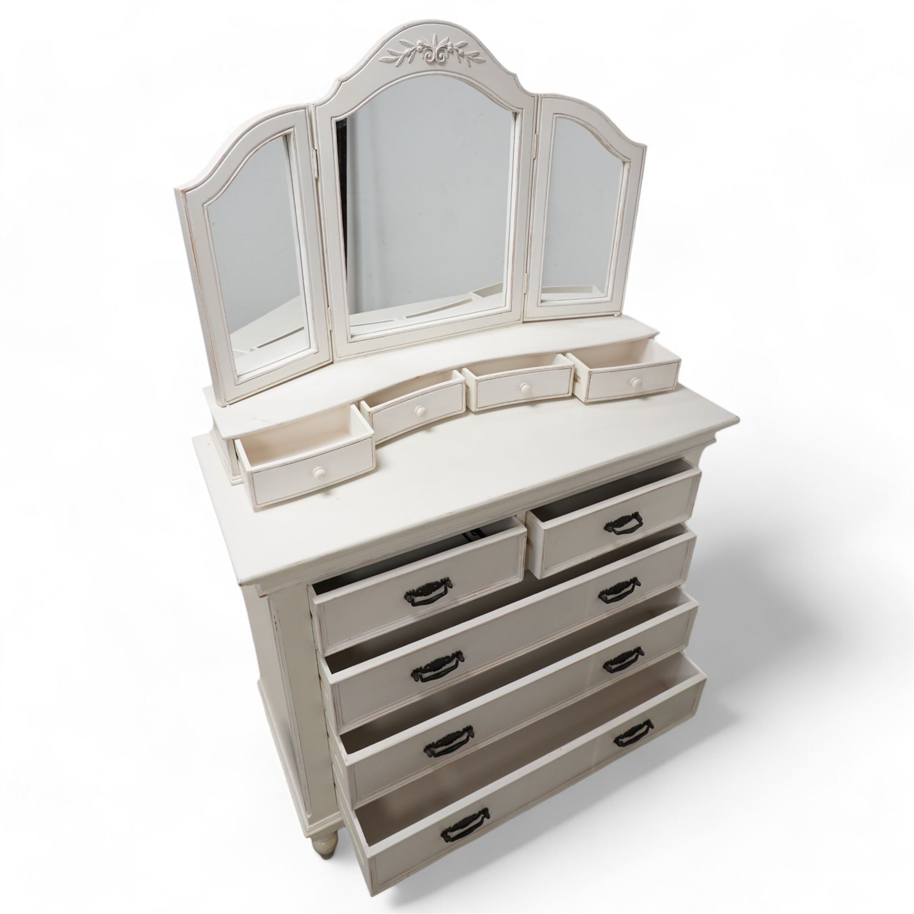 Country Corner - white painted chest with raised mirror back, triple mirror over four small drawers, the chest fitted with two short and three long drawers, on turned feet 