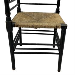 In the manner of William Morris - Arts & Crafts period corner chair, swell turned horizontal rails with balustrade back, rush seat on ring turned supports, black paint finish 