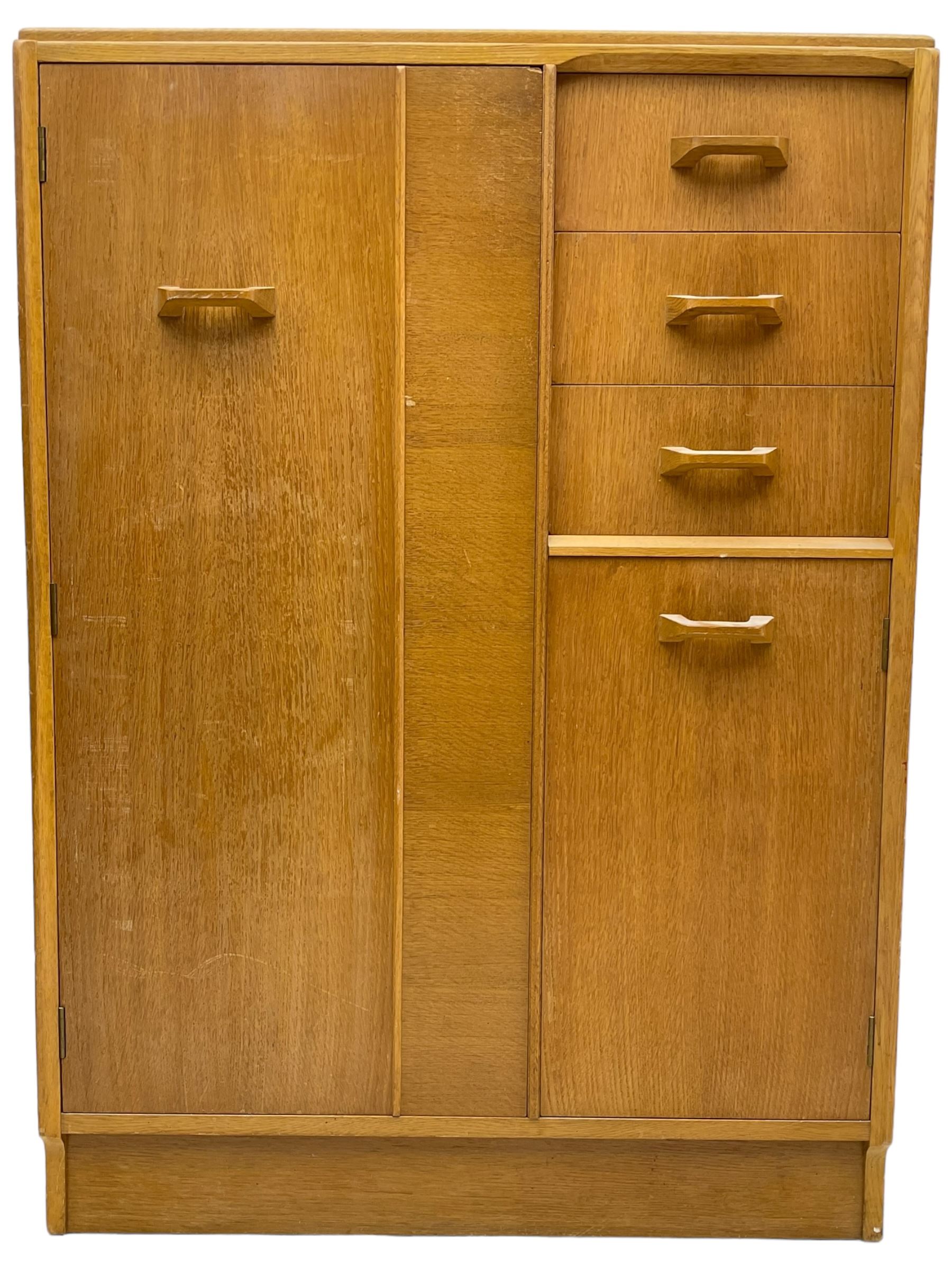 G-Plan - mid 20th century teak tallboy or combination wardrobe, left side with full-height hanging cupboard, right side with three drawers, the top fitted with vanity mirror, above cupboard with shelves, raised on a plinth base