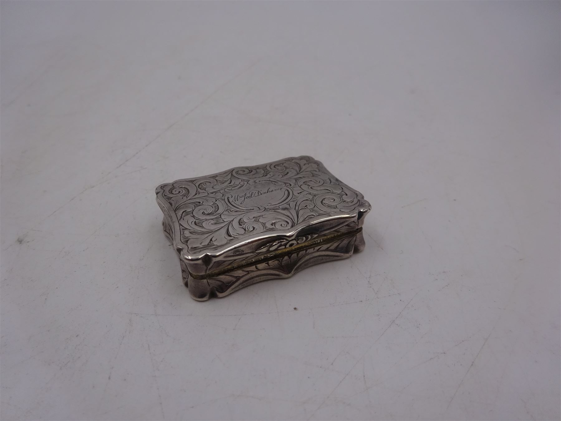 Victorian silver vinaigrette, with engraved name and scrolling decoration to hinged cover, the gilt interior with typical pierced cover, hallmarked Nathaniel Mills, Birmingham 1841, W3.7cm