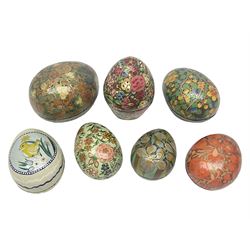 Seven lacquered boxes, of ovoid form, with floral decoration, largest H7cm, L10cm