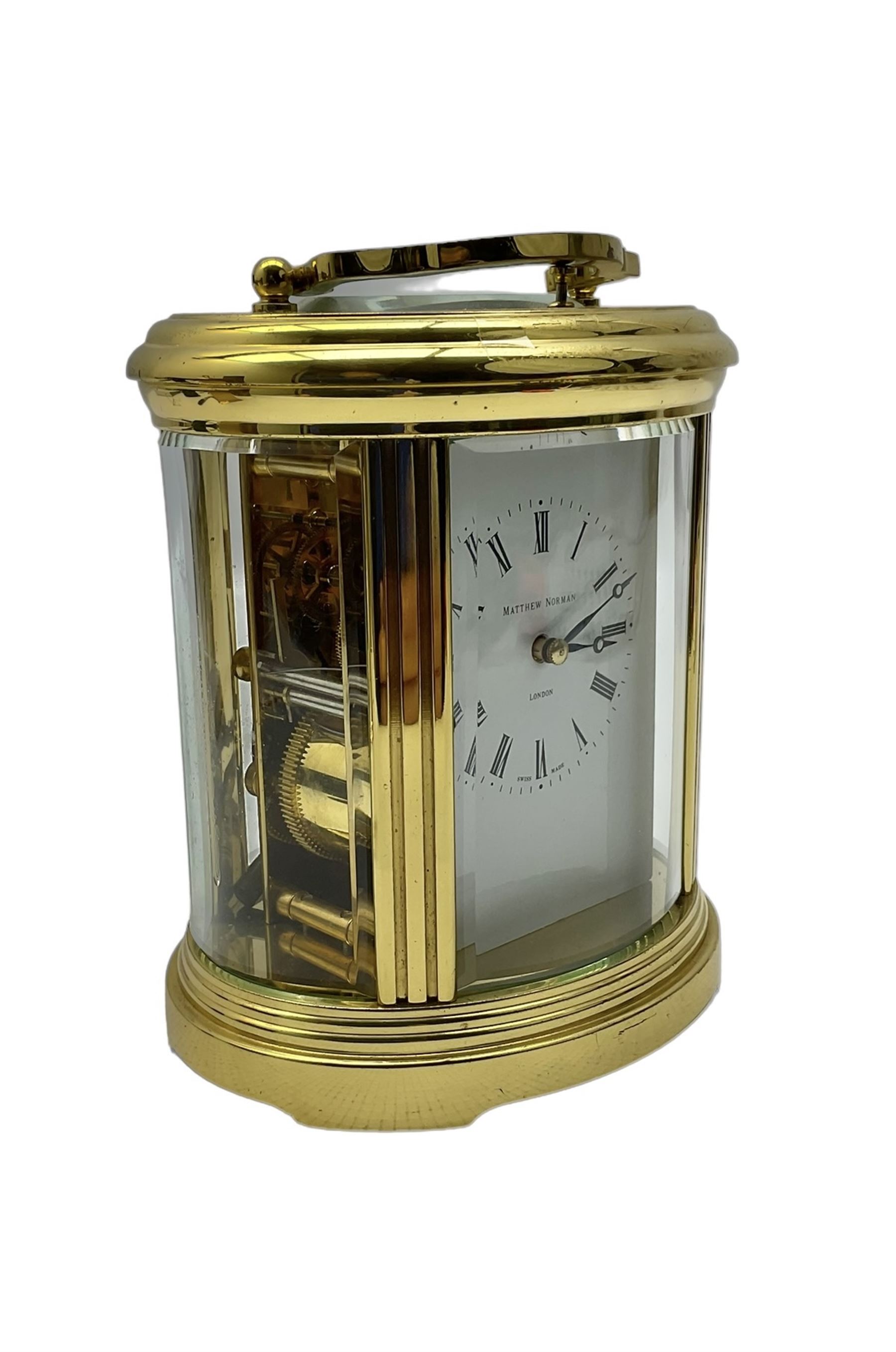 Matthew Norman - 20th century 8-day oval cased carriage clock, enamel dial with Roman numerals and minute markers, twin train rack striking movement with a lever platform escapement and repeat function, striking the hours and half hours on a coiled gong, with key.